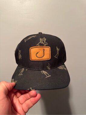 Avid Black Trucker Hat with Tan Leather Patch and Fishing Hook Graphic